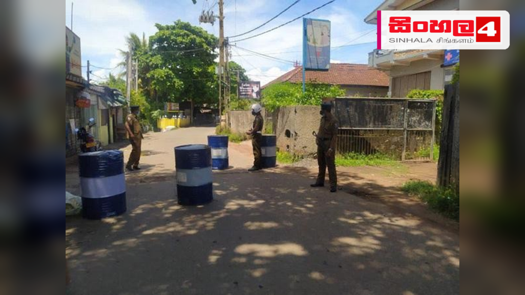 Headline: මොරටුමුල්ලේ දැව මෝලක් අසලින් මිනිස් හිසක් හමුවේ Intended image subject: Police investigation site at a timber mill in Moratumulla Story summary: මොරටුමුල්ල ප්‍රදේශයේ දැව